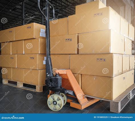 Stack Of Shipments Boxes On Pallet Waiting For Load Into A Truck Road