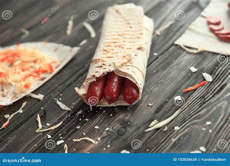 Spicy Sausages In Pita Bread On A Wooden Table Stock Photo Image Of