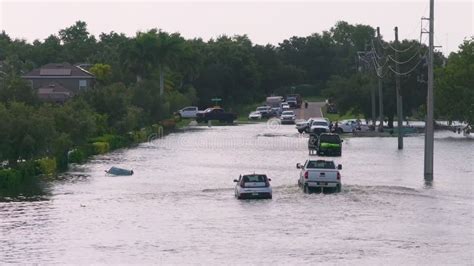 Flooded Street After Hurricane Rainfall With Driving Cars In Florida