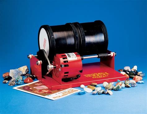 A Red And Black Machine Sitting On Top Of A Blue Table Next To Some Rocks