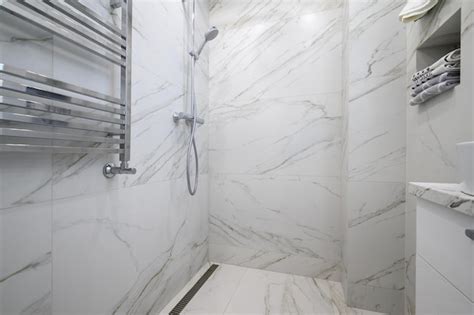 Premium Photo | White bathroom interior with marble tiles on the walls