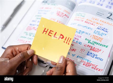 Close Up Of Person S Hand Holding Adhesive Note With Help Text Over