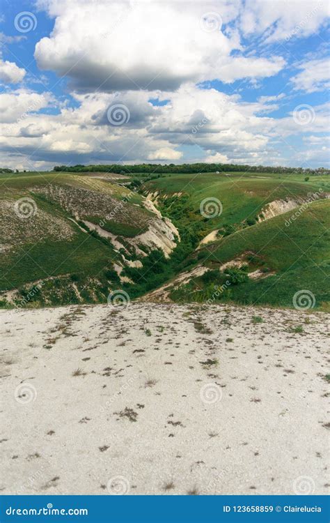 Beautiful View Of Grassy Ravine On Sky Background With Clouds Vertical