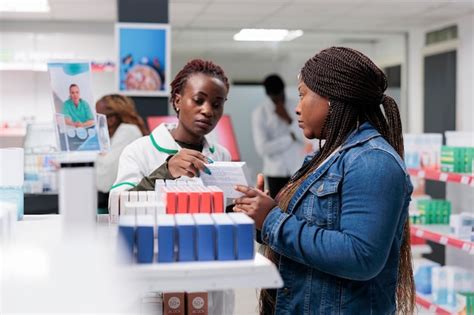 Farmacéutica afroamericana mostrando medicamentos de clientes en el