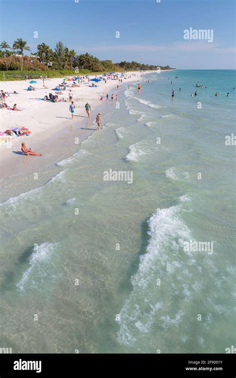 White Sandy Beach And Green Water Along The Gulf Of Mexico At Naples