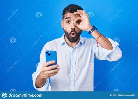 Hispanic Man With Beard Using Smartphone Typing Message Doing Ok