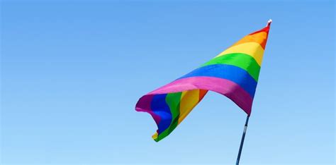 Premium Photo Gay Rainbow Flag Waving In The Wind In A Clear Blue Sky