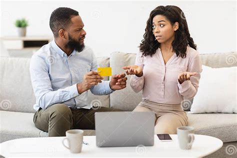 Angry Black Husband Blaming His Wife For Wasting Money Stock Image