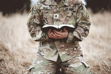 Premium Photo Shallow Focus Shot Of A Young Soldier Kneeling While