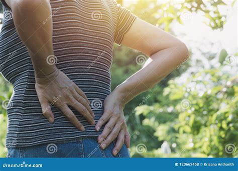 A Woman Suffering From Backache Spinal Injury And Muscle Issue Stock