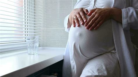 Close Up Of Pregnant Woman Gravid Female Expectant Mother In White