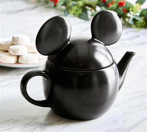 A Mickey Mouse Teapot With Marshmallows On The Side