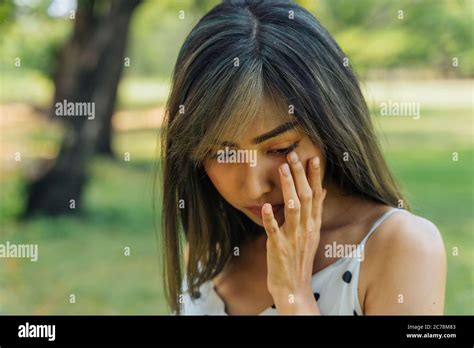 Young Brunette Woman Crying And Wiping Tears In The Park Beautiful