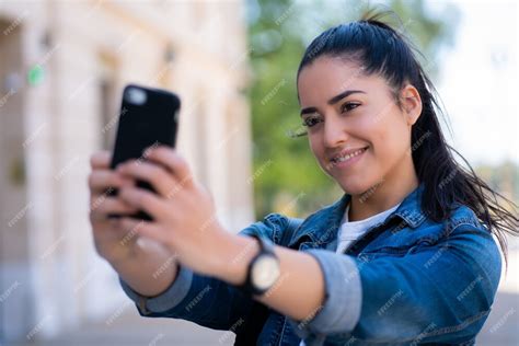 Free Photo Portrait Of Young Woman Taking Selfies With Her Mophile