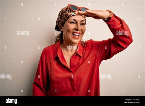 Middle Age Brunette Woman Wearing Handkerchief On Head And Shirt Over