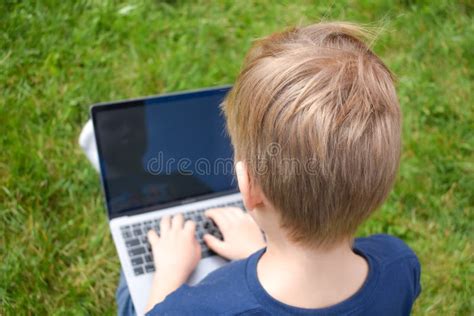 The Student Learns In The Garden On The Computer The Online Schooling