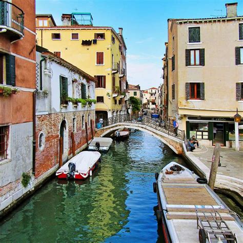 Boat On River Between Buildings During Daytime Sliding Puzzle On