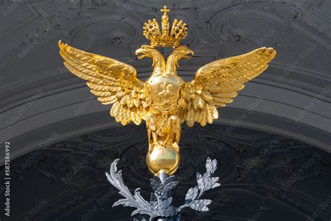 Double-headed eagle - coat of arms of the Russian Empire close-up. Fragment of the main gate of ...