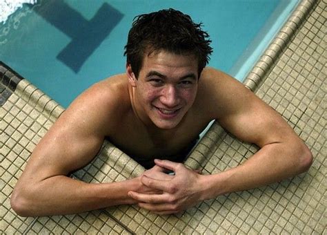 A Man Laying On The Edge Of A Swimming Pool With His Arms Crossed And