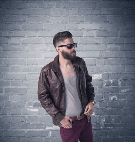 A Stylish Hipster Guy With Beard And Sunglasses Standing In Casual