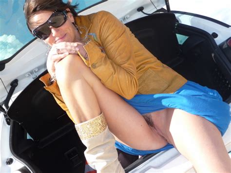 Sitting On The Car Boot And Showing Off Her Pussy In A Short Skirt
