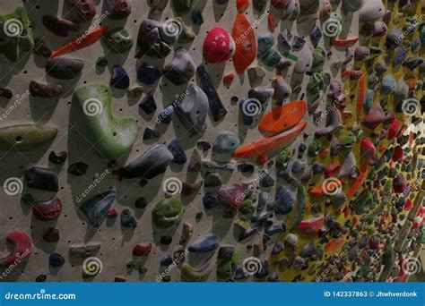 Large Wall Full Of Grips To Climb Up During A Bouldering Session Stock