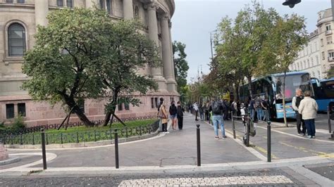 People Watching The Traffic On Andrassy Road In Budapest In Front Of