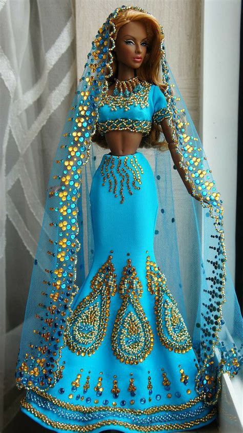 A Barbie Doll Dressed In A Blue And Gold Dress With An Elaborate Headdress