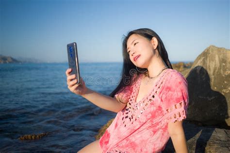 Young Happy And Beautiful Asian Woman Taking Selfie With Mobile Phone