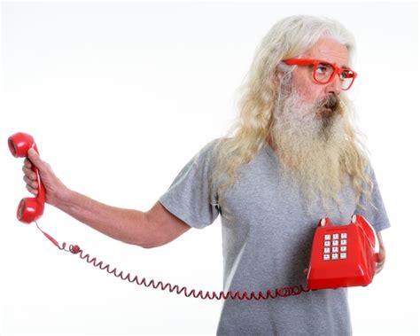 Premium Photo Senior Bearded Man Holding Old Telephone