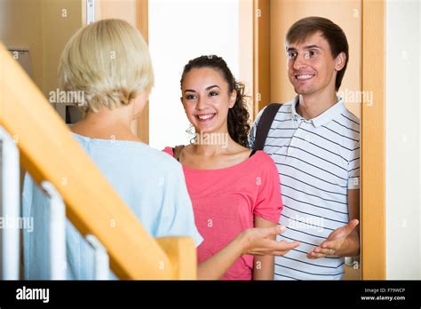 Happy Mature Mother Meets Son With His Wife At Doorway Stock Photo Alamy