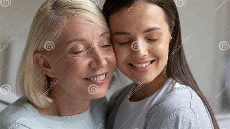 Close Up Smiling Mature Mother And Daughter Enjoying Tender Moment