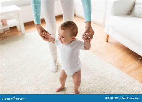 Bambino Felice Che Impara Camminare Con Aiuto Della Madre Immagine