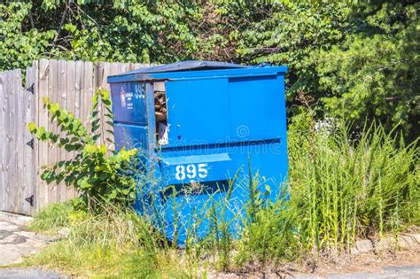 A Blue Dumpster With Overgrown Weeds Stock Photo Image Of Dump
