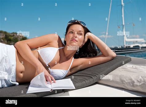 Attractive Woman Sunbathing On Luxury Boat Reading Book In Bikini Stock Photo Alamy