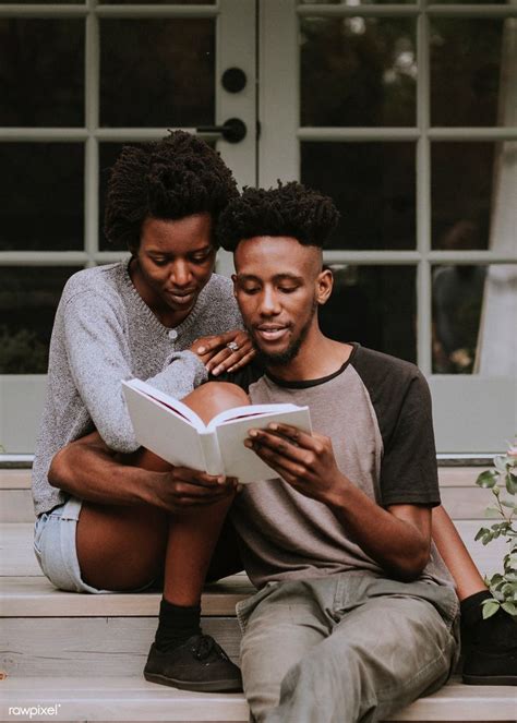 Cute Black Couple Reading A Book Together In A Garden Premium Image