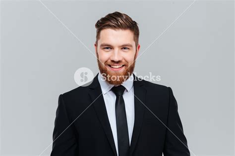 Smiling Business Man In Black Suit With Tie In Studio Looking At Camera