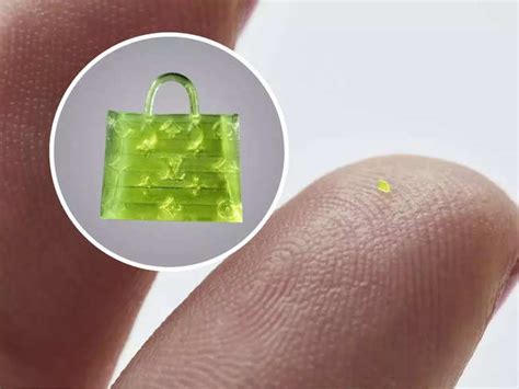 This Fluorescent Green Speck On The Finger Is A Microscopic Handbag A