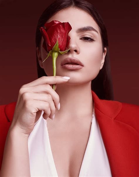 Premium Photo Elegant Beautiful Woman In A Red Fashionable Suit With Rose