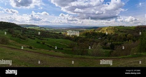 Rolling Hills Over English Countryside With Blue Sky And White Clouds