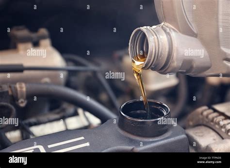 Pouring oil to car engine, close up Stock Photo - Alamy