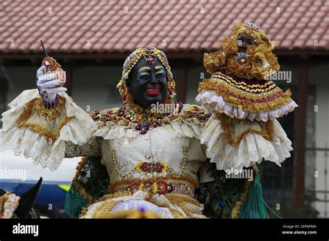 A performer dressed as the Mama Negra walks the streets during the Mama ...