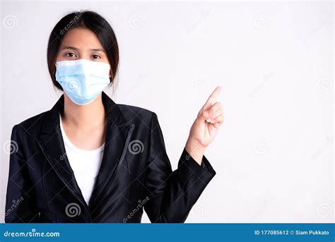 Close Up Of A Businesswoman In A Suit Wearing Protective Face Mask