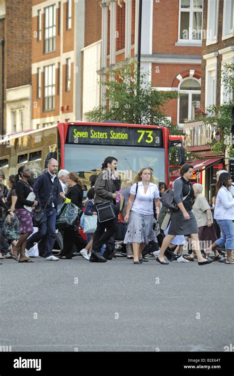 Pedestrians Crossing Road At Lights Angel Islington London Uk Stock