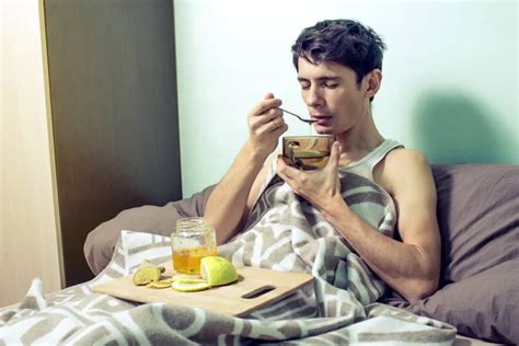 Young Man Lies In Bed Sick With Colds And Flu Stock Image Everypixel