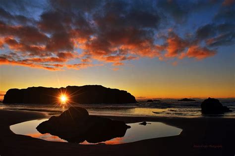 Sunset Through Sea Stack Photograph by Renita Confer - Fine Art America