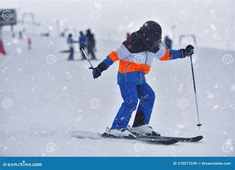 Speed And Adventure 10 Year Old Boy Skiing Down A Sunny Slope With The