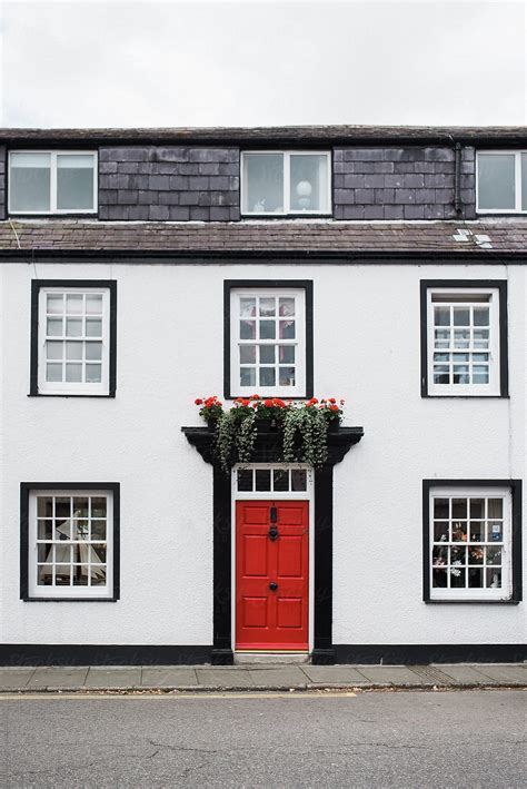 "White House With Red Door" by Stocksy Contributor "Léa Jones" - Stocksy