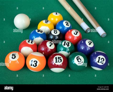 Mini billiards, pool or snooker balls on the green felt. Fourteen ...