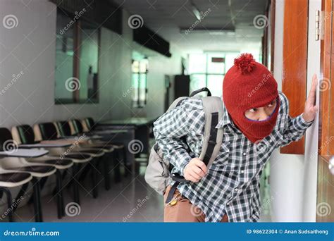 Masked Burglar With Crowbar In The Background Bank Vault Doors Large